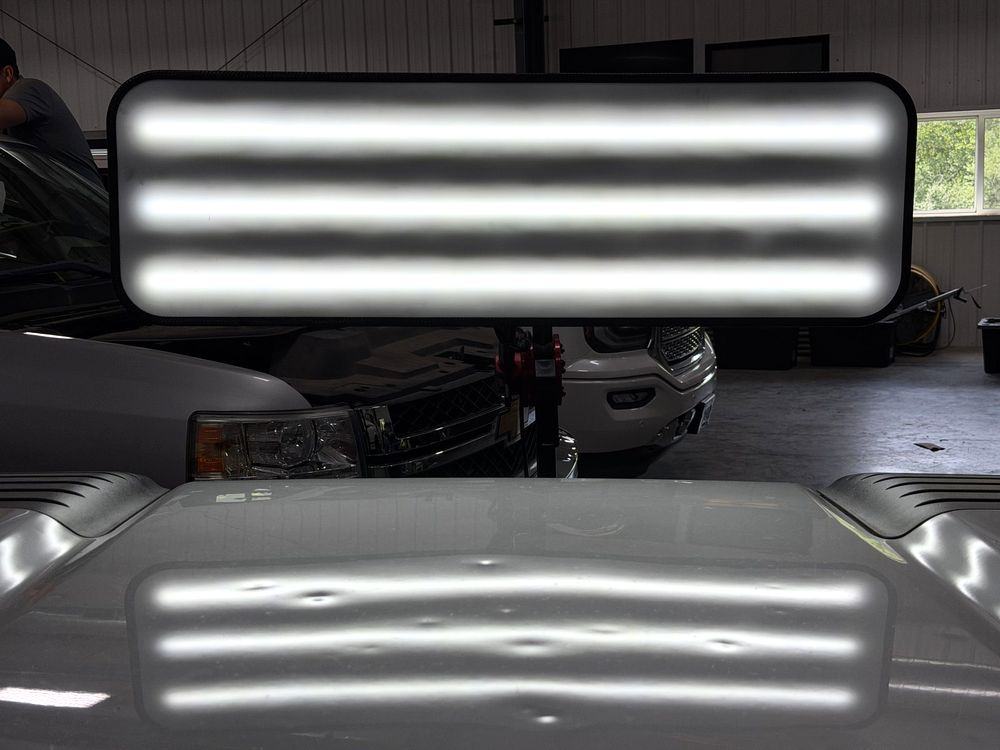 Hail-damaged vehicle hood before paintless dent repair in Green Bay, Wisconsin